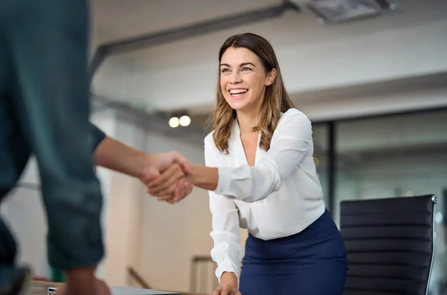 happy mid aged business woman manager handshaking greeting client in office smiling female